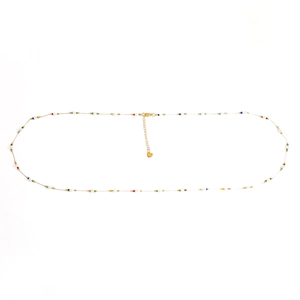 Detail of slim gold beaded waist chain with colorful micro beads and a heart pendant
