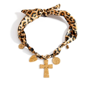 Leopard print silk scarf necklace with golden cross and heart pendants on white background