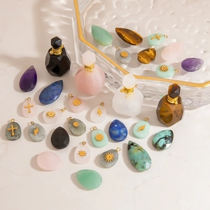 Macro detail of natural stone perfume bottles and pendants with golden cross motifs