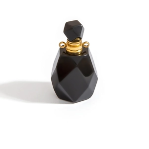Polished black gemstone perfume bottle pendant with gold hardware and geometric facets