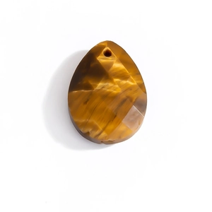 Macro shot of faceted tiger eye stone pendant in water drop shape for jewelry making