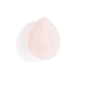 Detail of rose quartz tear-drop massage stone with polished texture and smooth edges