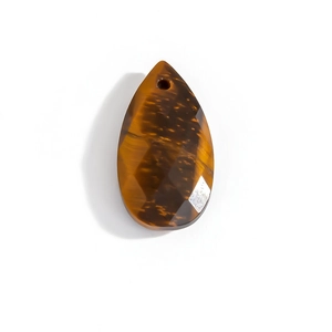 Macro shot of faceted tiger eye stone pendant in a drop shape for necklace jewelry making