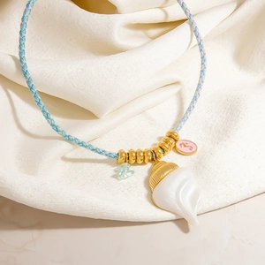 Colorful woven cord necklace featuring a large white conch shell and seahorse charm