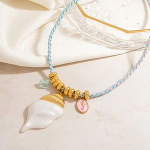 Colorful woven cord necklace featuring a white conch shell pendant and charms