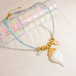 Bohemian ocean themed necklace with white seashell pendant and blue braided cord