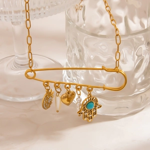Gold safety pin necklace with shell, pearl, heart, and Hamsa turquoise charms