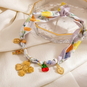 Bohemian 18K gold necklace with tropical charms and colorful floral silk ribbon