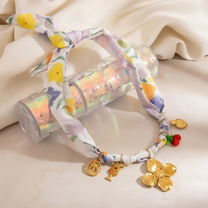 Bohemian style printed fabric necklace with 18K gold charms and floral pattern pendants