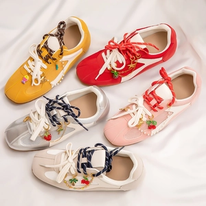 Detailed top view of colorful sneakers with tropical charms like cherry and palm trees