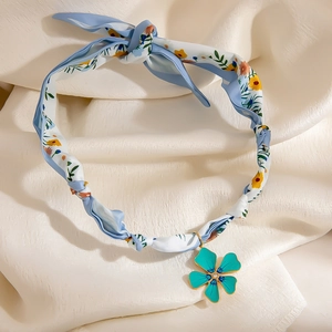 Floral print silk scarf necklace with a gold-edged turquoise flower pendant