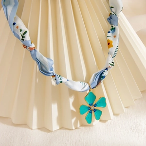 Teal flower pendant necklace with blue floral silk ribbon and gold metal trim