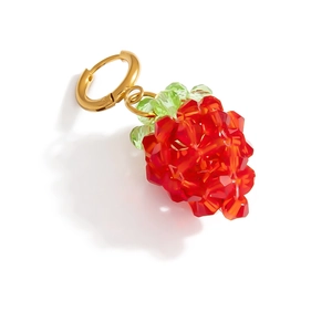 Macro view of strawberry charm earring crafted with red faceted crystal beads and gold metal