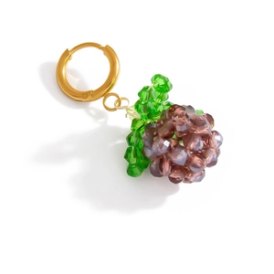 Macro detail of grape-shaped crystal earring with purple and green beads and golden hoop