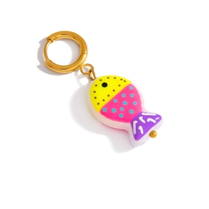 Detail of a colorful fish charm on a gold metal ring with vibrant resin finish
