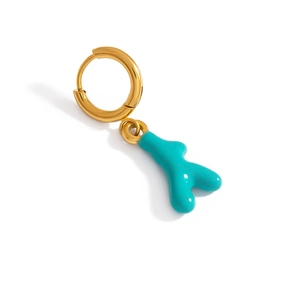 Golden hoop earring with bright turquoise coral-shaped charm on a white background
