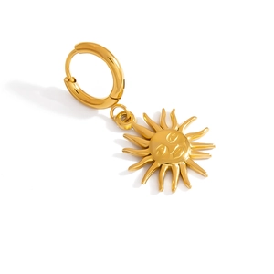 Macro view of gold-plated sunface pendant with rays in vintage stainless steel style