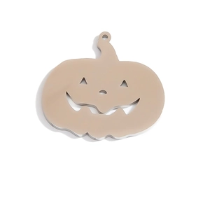Macro detail of silver stainless steel pumpkin charm with cutout smile for DIY jewelry