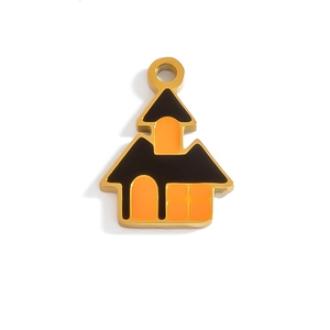 Macro shot of Halloween house pendant with gold trim and orange enamel details