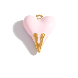 Macro detail of a 3D pink enamel heart pendant with golden drip design for jewelry