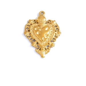 Detailed view of a vintage gold heart charm with baroque hollowed filigree patterns