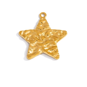 Detail of a gold star pendant featuring a unique hammered water-ripple texture and top ring