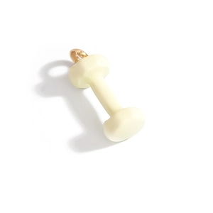 Detailed view of cream yellow dumbbell pendant with polished gold metal loop
