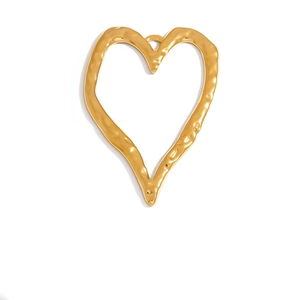 Detailed macro view of heart pendant with irregular hammered texture in gold finish
