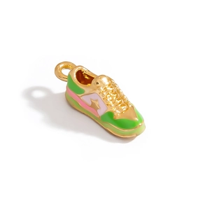 Detailed shot of a colorful sneaker pendant featuring gold finish and enamel accents