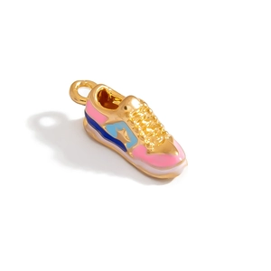 Detailed macro view of a 3D sneaker charm pendant with colorful enamel and gold finish