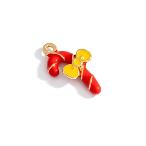Detail of alloy Christmas candy cane pendant with red enamel and golden bow accent