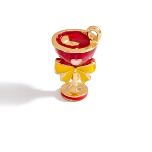 Detail of enamel cocktail glass charm with red finish and pink heart bow