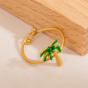 Macro shot of gold adjustable ring featuring a vibrant green palm tree pendant detail
