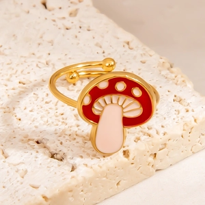 Minimalist gold mushroom ring with red and white drip oil glaze on travertine stone