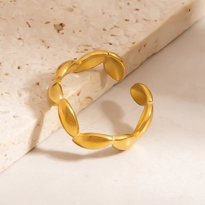 Gold stainless steel open ring with petal leaf segments on a stone pedestal