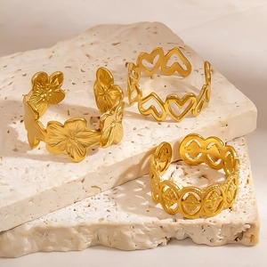 Detailed view of adjustable gold-plated stainless steel rings with floral and heart cutouts