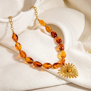 Boho amber beaded necklace with sunburst golden heart pendant and gemstone inlay