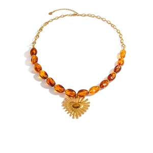 Vintage stainless steel necklace with amber resin beads and a heart sunburst pendant