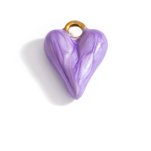 Macro detail of a heart-shaped purple fluid pendant with glitter and a golden ring