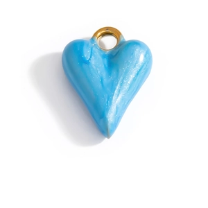 Detail of light blue enamel heart pendant with glitter and gold loop on white background