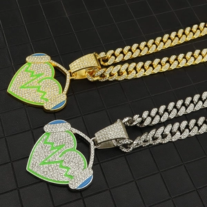 Detail of hip hop cuban link chains with iced out gold and silver headphone heart pendants