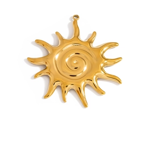 Detailed view of sun-shaped golden stainless steel pendant with spiral center design