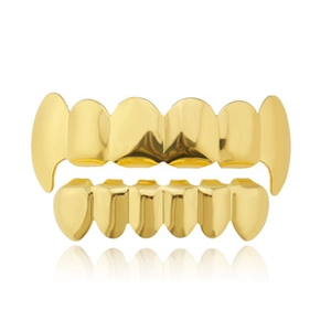 Polished gold-plated hip hop grillz set featuring vampire fangs on minimalist background