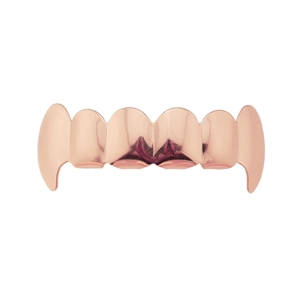 Close-up of rose gold vampire fangs teeth grillz with high polished metal finish