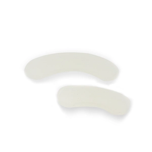 Detail view of two white crescent-shaped soft silicone pads for hip hop teeth grillz fixing