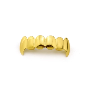 Detailed macro view of the gold plated six-teeth grillz with a hip hop decorative style