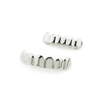 Polished silver teeth grillz set with shiny metallic finish on white background