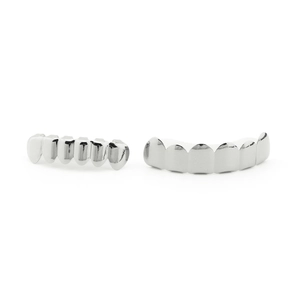 Detailed macro view of silver polished hip hop grillz teeth set on white background