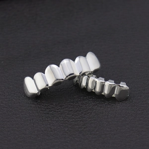Polished silver Hip Hop Teeth Grillz set for top and bottom rows on black leather
