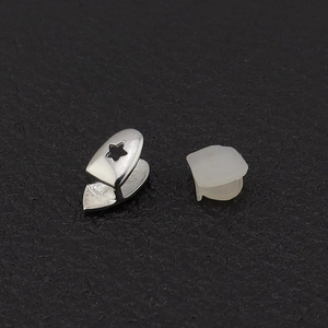 Single silver tooth grillz with star cutout detail and fixing silicone mold